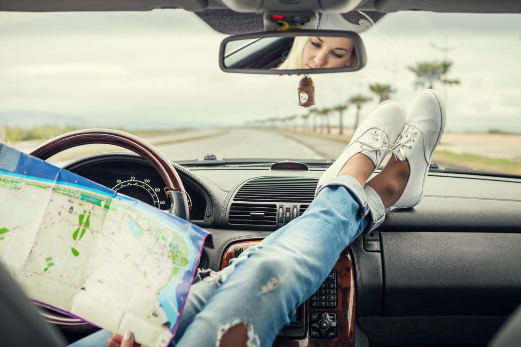 43468794 - young woman alone car traveler with map